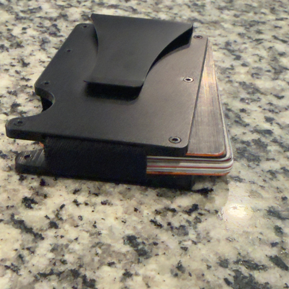 Side view of wallet holding cards with elastic band
